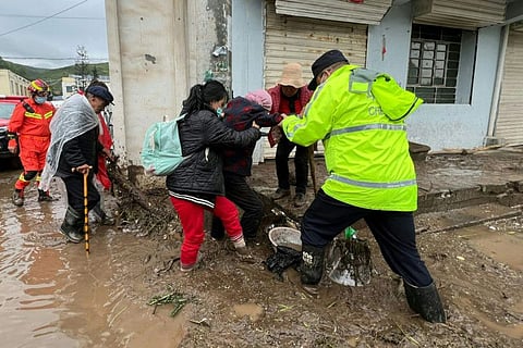 Rescue workers evacuating residents after a flash flooding caused by a sudden downpour triggered mudslides in Datong county, Xining city, in China's northwestern Qinghai province.  