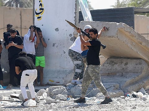 Armed members of Saraya Al Salam (Peace Brigade), the military wing affiliated with Moqtada Sadr, are pictured during clashes with Iraqi security forces in Baghdad's Green Zone on August 30, 2022.  
