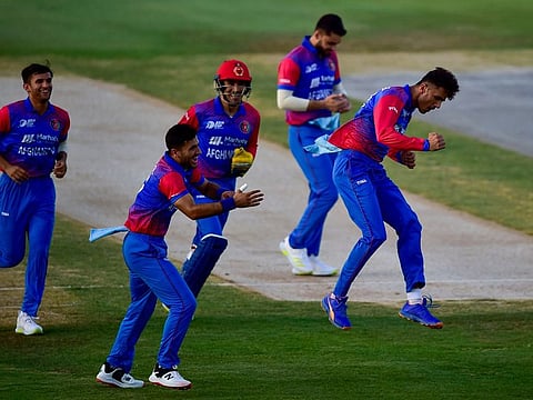 Afghanistan's Mujeeb ur Rahman celebrates after taking the wicket of Bangladesh batsman Mohammad Naim during the Group B Asia Cup 2022 clash at the Sharjah Cricket stadium. They won the match by 7 wickets.