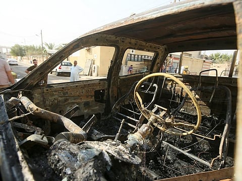 A burnt vehicle on a street aftermath of clashes among rival Shiite militants in Basra on September 1, 2022. 
