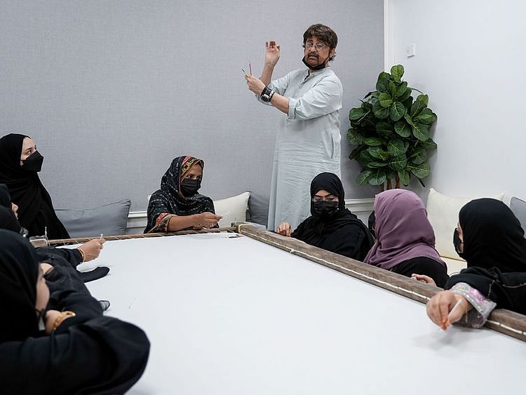 Rizwan Beyg, Pakistan’s award-winning fashion designer, guiding the artisans in Kalba