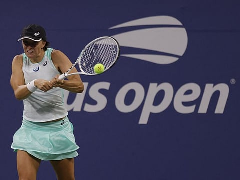 Iga Swiatek hits a backhand against Lauren Davis on day six of the 2022 U.S. Open tennis tournament at USTA Billie Jean King Tennis Center. 