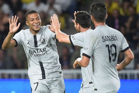 Paris Saint-Germain's Kylian Mbappe (left) celebrates with Lionel Messi (centre) after scoring his team's first goal during the French L1 match against FC Nantes at the Stade de la BeaujoireLouis Fonteneau in Nantes, western France.