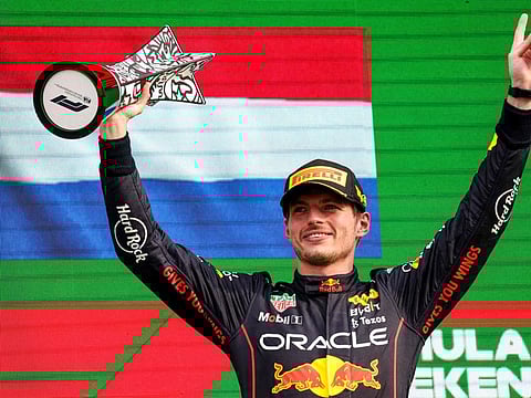 Red Bull Racing's Dutch driver Max Verstappen holds the winner's trophy on the podium of the Dutch Formula One Grand Prix at the Zandvoort circuit.