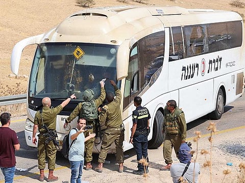 Members of Israeli security forces and emergency services inspect the site of a reported attack on an Israeli bus, east of Tubas village in the north of the occupied West Bank, on Septembre 4, 2022. 