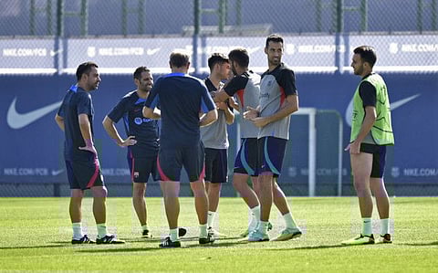 FC Barcelona coach Xavi and Sergio Busquets during a training session ahead of their Group C Champions League clash against Viktoria Plzen tomorrow night. 