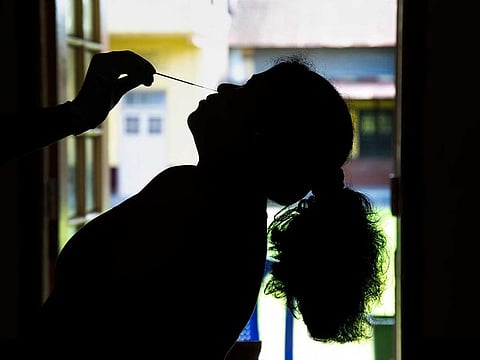 A health worker takes a nasal swab sample of a woman to test for COVID-19 before she receives the vaccine in Gauhati, India, Friday, June 18, 2021. 