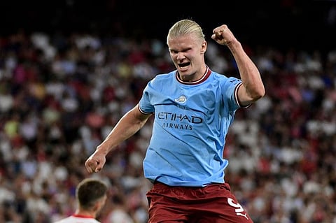 Manchester City's striker Erling Haaland celebrates after scoring his team's third goal during the UEFA Champions League Group G first-leg match against Sevilla FC at the Ramon Sanchez Pizjuan stadium in Seville.