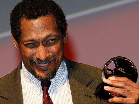 US writer Percival Everett holds his trophy after he was awarded with the Literary Award at the 38th American Film Festival Sept. 5, 2012, in Deauville, Normandy, France. American authors Elizabeth Strout and Percival Everett are up against writers from Britain, Ireland, Zimbabwe and Sri Lanka as finalists for the prestigious Booker Prize for fiction.
