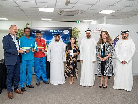 Lieutenant-Colonel Khaled Ismail, Secretary-General of the award, in the middle of the picture, and to his left, Mohammed Al Mazimi, with representatives of some of the winning companies and workers