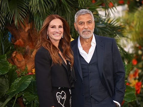 Julia Roberts, left, and George Clooney pose for photographers upon arrival for the world premiere of the film 'Ticket To Paradise' in London, Wednesday, September 7.