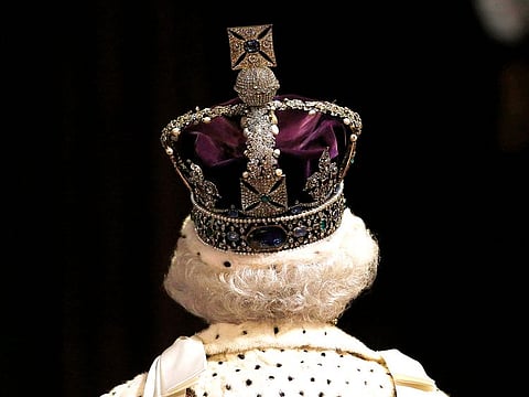 Queen Elizabeth II wears the Imperial State Crown as she proceeds through the Royal Gallery,  May 27, 2015