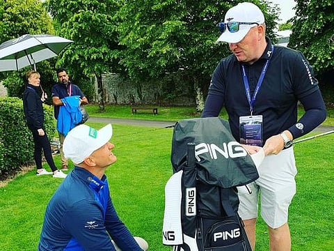 Adrian Meronk and caddy just checking out their golf bag.
