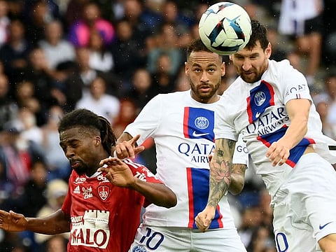 Brest's defender Jean-Kevin Duverne (left), Paris Saint-Germain's forward Neymar (centre) and Lionel Messi jump to head the ball during the French L1 match at the Parc des Princes Stadium in Paris.