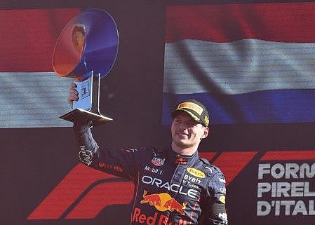 Red Bull's Max Verstappen celebrates with the trophy on the podium after winning the Italian Grand Prix.