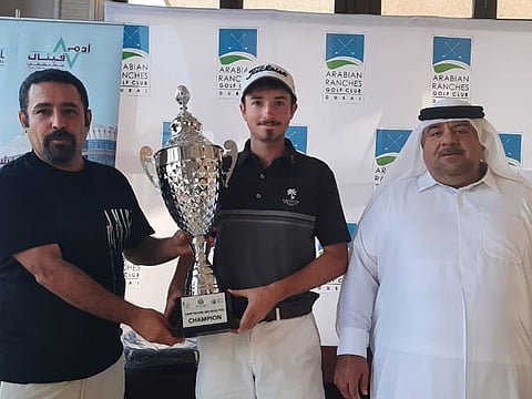 Winner of the Men's Division, Dan Byrne (centre) with officials.