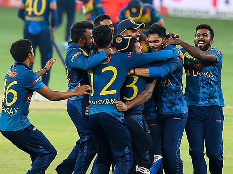Sri Lanka team members mob Wanindu Hasaranga after their win over Pakistan in the Asia Cup final at Dubai International cricket stadium.