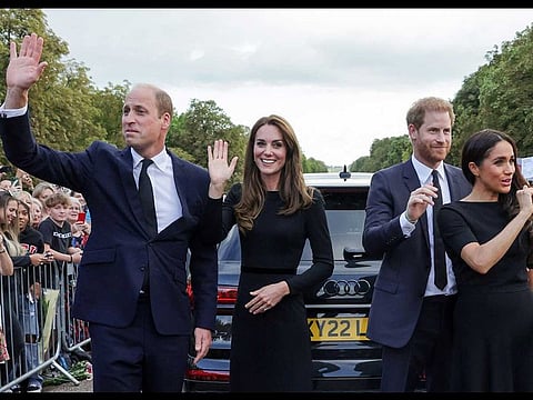 (L-R) Britain's Prince William, Prince of Wales, Catherine, Princess of Wales, Prince Harry, Duke of Sussex, Meghan, Duchess of Sussex, wave at well-wishers on the Long walk at Windsor Castle on September 10, 2022. 