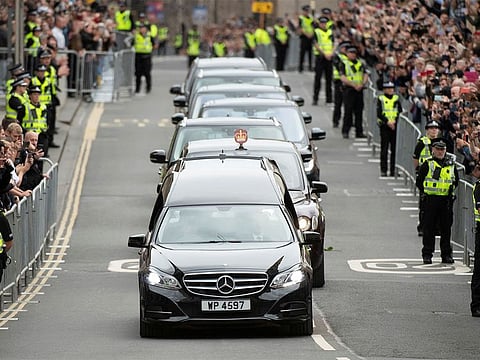 The hearse carrying the coffin of Queen Elizabeth II, passing along the Royal Mile.