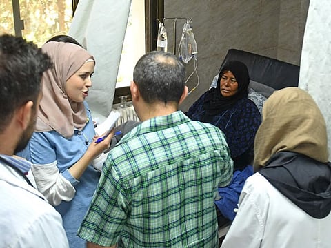 A cholera-infected woman receives treatment at a hospital in Syria's northern city of Aleppo on September 11, 2022.  