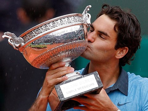 Switzerland's Roger Federer kisses the trophy after defeating Sweden's Robin Soderling to win his sole French Open trophy.
