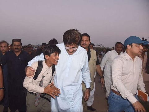 Syed Murad Ali Shah with his 'tour guide' in the 'tent city'.