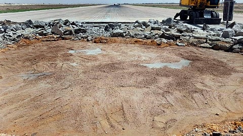 A bulldozer working on a damaged runway of the Damascus International Airport, which was hit by an Israeli airstrike, on June 12, 2022.  
