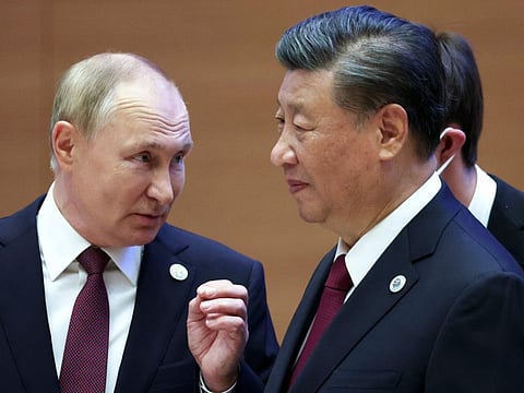 Russian President Vladimir Putin, left, gestures while speaking to Chinese President Xi Jinping during the Shanghai Cooperation Organisation (SCO) summit in Samarkand, Uzbekistan, on September 16.