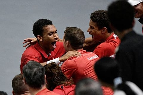 Canada's Felix Auger Aliassime celebrates with his team after winning his match against Serbia's Miomir Kecmanovic.