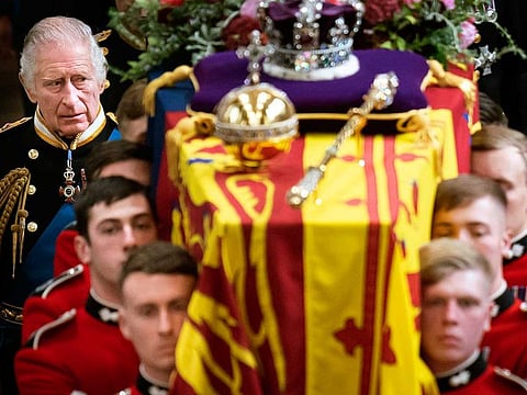 King Charles III and members of the Royal family follow behind the coffin of Queen Elizabeth II, draped in the Royal Standard with the Imperial State Crown and the Sovereign's orb and sceptre,  as it is carried out of Westminster Abbey after her State Funeral, in London, Monday Sept. 19, 2022.  