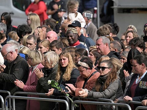 Members of the public pay their respects as they attend the coffin Procession from Westminster Abbey to Wellington Arch in London on September 19, 2022, after the State Funeral Service of Britain's Queen Elizabeth II.  