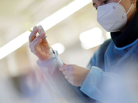 A nurse prepares a booster dose of the Moderna COVID-19-19 vaccine. The COVID-19 vaccines used in the United States do not contain aborted fetal cells. Laboratory-grown cells that descended from the cells of an aborted fetus obtained decades ago were used in the testing process. The Vatican issued guidance to Catholics in 2020 that it is morally acceptable to use COVID-19 vaccines.