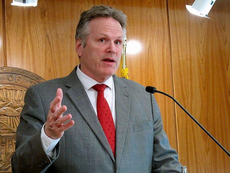 Alaska Gov. Mike Dunleavy speaks to reporters