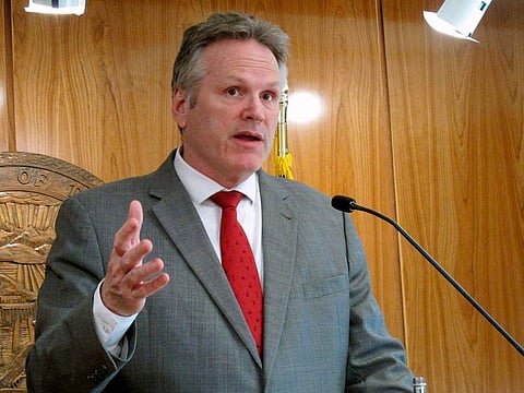 Alaska Gov. Mike Dunleavy speaks to reporters