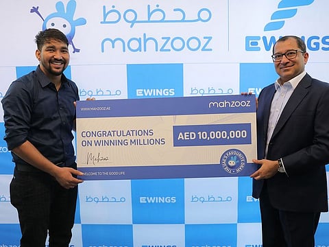 Nepalese Bharat, 31, (left) receives a symbolic Dh10million cheque from Farid Samji, CEO of Ewings, operator of Mahzooz