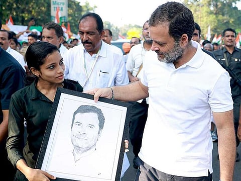 A supporter presents a sketch to Congress leader Rahul Gandhi during his party's Bharat Jodo Yatra, in Ernakulam on Thursday, September 22, 2022. 
