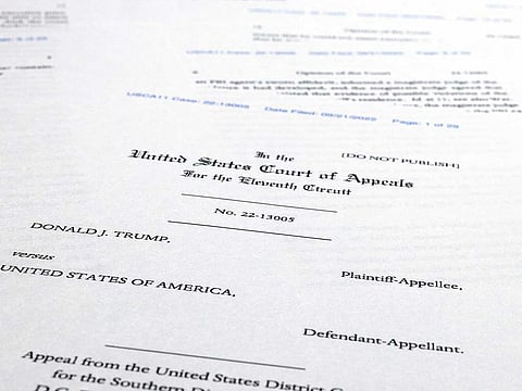 Pages from a U.S. Court of Appeals for the 11th Circuit in Atlanta ruling that lifts a judge's hold on the Justice Department's ability to use classified documents seized by the FBI at Trump's Mar-a-Lago estate, are photographed Wednesday, Sept. 21, 2022. 