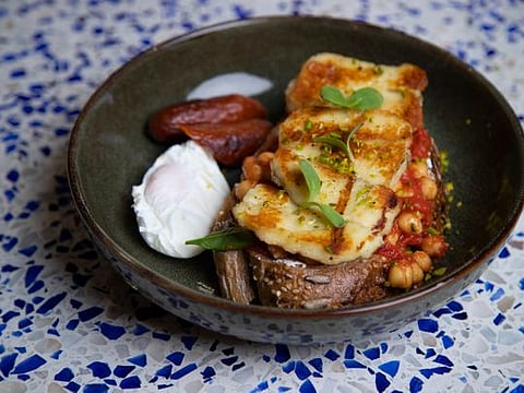 Easy Arabic breakfast with poached egg, beef sausages, grilled halloumi and tangy Shakshouka