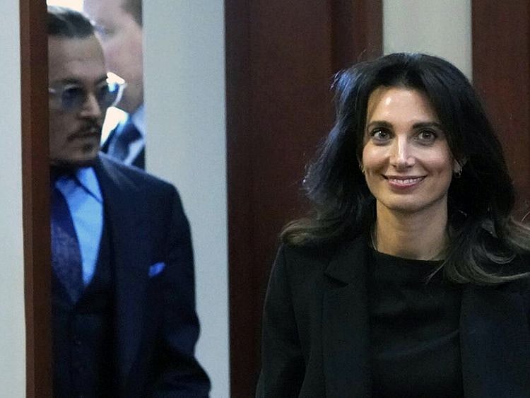 Joelle Rich, of Schillings in London, right, walks into courtroom along with actor Johnny Depp after a break at the Fairfax County Circuit Courthouse in Fairfax, Va., Monday, May 2, 2022.
