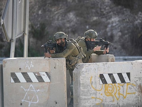 Israeli soldiers take position at a roadblock near the West Bank town of Nablus, on September 24 2022. 