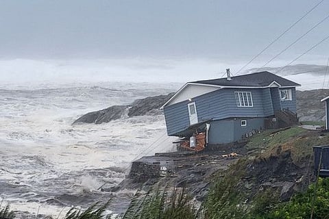 Waves roll in near a damaged house built close to the shore as Hurricane Fiona, later downgraded to a post-tropical cyclone, passes the Atlantic settlement of Port aux Basques, Newfoundland and Labrador, Canada September 24, 2022.