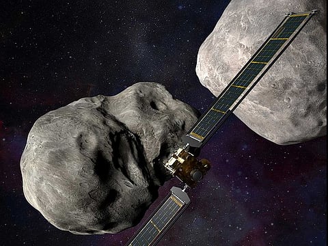 This illustration made available by Johns Hopkins APL and NASA depicts NASA's DART probe, center, and Italian Space Agency's (ASI) LICIACube, bottom right, at the Didymos system before impact with the asteroid Dimorphos, left. DART is expected to zero in on the asteroid Monday, Sept. 26, 2022, intent on slamming it head-on at 14,000 mph. The impact should be just enough to nudge the asteroid into a slightly tighter orbit around its companion space rock. 