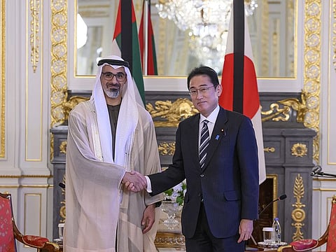Sheikh Khaled bin Mohamed bin Zayed Al Nayan (L) with Prime Minister of Japan Fumio Kishida in Tokyo