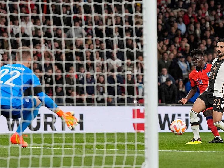 Germany's goalkeeper Marc-Andre ter Stegen, left, makes a save from England's Bukayo Saka during the UEFA Nations League soccer match between England and Germany at the Wembley Stadium in London, 