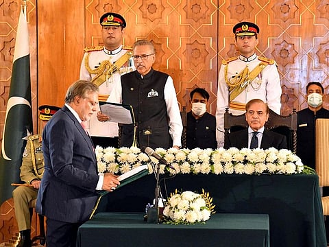  Pakistan's new Finance Minister Ishaq Dar takes oath from the Pakistan's President Arif Alvi, in Islamabad, on September 28, 2022.  