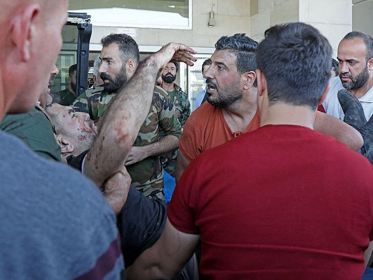 A wounded man is transported to a hospital following an overnight attack on the village of Altun Kupri, south of the capital Arbil in Iraq’s autonomous Kurdistan region, on September 28, 2022.
