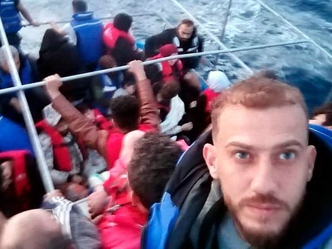 Jihad Michlawi takes a selfie on board an overcrowded migrant boat carrying about 150 Lebanese, Syrians, and Palestinians in the Mediterranean Sea on September 21, 2022.  