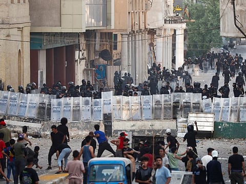 Police officers stand guard as demonstrators gather during an anti-government protest, after a parliament session, in Baghdad, Iraq September 28, 2022.  