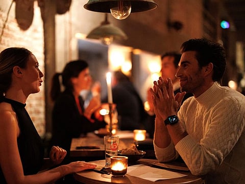 Diners have a candle lit dinner at Brasserie Surrealiste in Brussels on September 28, 2022.  