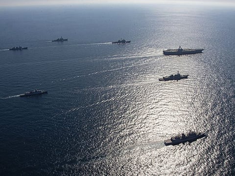 US aircraft carrier USS Ronald Reagan, top right, participates with other US and South Korean navy ships during the joint naval exercises between the United States and South Korea in waters off South Korea's eastern coast in South Korea, on September 29, 2022. 
